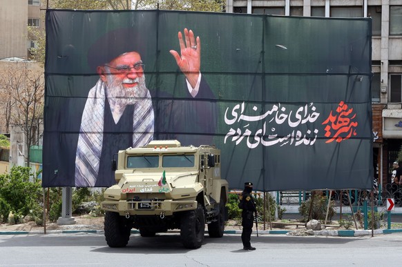 epa12860084 A member of the Iranian security forces stands guard next to a banner honouring former Iranian supreme leader Ali Khamenei, in Tehran, Iran, 30 March 2026. A joint US and Israeli military  ...