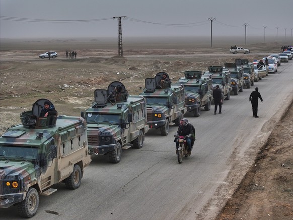 Syrian security forces gather before entering the town of al-Hassakeh to implement an agreement with the Kurdish-led Syrian Democratic Forces (SDF) to stabilize a ceasefire, in Wadi al-Raml, al-Hassak ...
