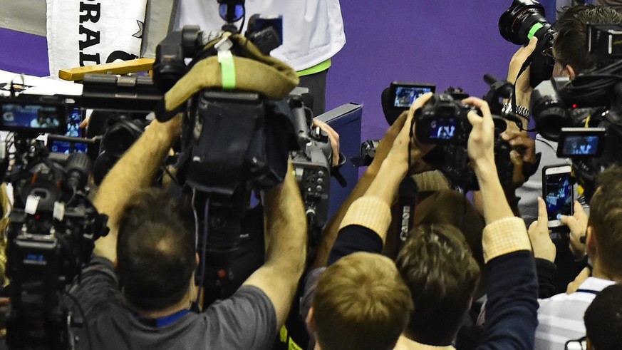 epa04589479 Seattle Seahawks player Richard Sherman takes pictures of the media during media day for the Seattle Seahawks players in Phoenix, Arizona, USA, 27 January 2015. Super Bowl XLIX game betwee ...