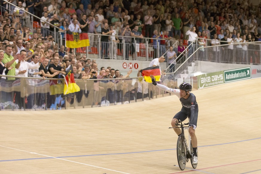 epa04406268 German cyclist Jens Voigt celebrates after breaking the one hour cycling world record at the velodrome Suisse in Grenchen, Switzerland, 18 September 2014. The new world records is now at 5 ...