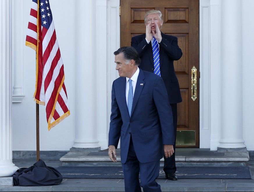 President-elect Donald Trump calls out to the media as Mitt Romney leaves Trump National Golf Club Bedminster in Bedminster, N.J., Saturday, Nov. 19, 2016. (AP Photo/Carolyn Kaster)