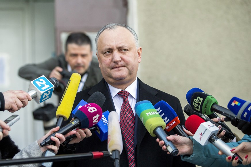 epa07392342 The President of Moldova Igor Dodon (C) speaks to media after voting at a polling station during parliamentary elections in Chisinau, Moldova, 24 February 2019. Moldovan voters are going t ...