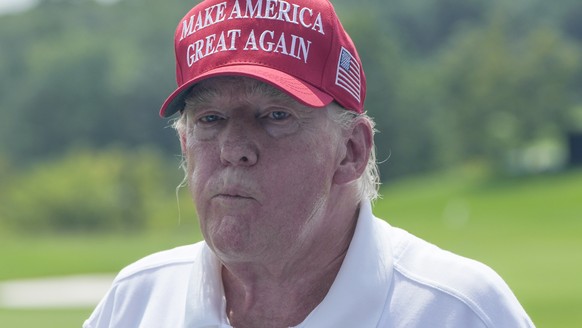 Former President Donald Trump greets golfers and supporters on the driving range before the start of the final round of the Bedminster Invitational LIV Golf tournament in Bedminster, N.J., Sunday, Aug ...