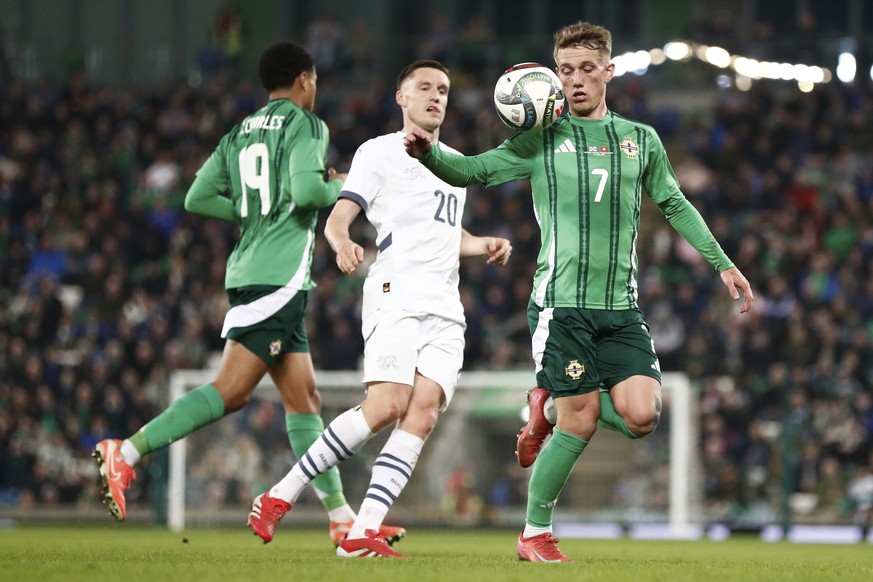 Northern Ireland&#039;s Ethan Galbraith controls the ball by the Switzerland&#039;s Michel Aebischer, center, during the international friendly soccer match between Northern Ireland and Switzerland at ...