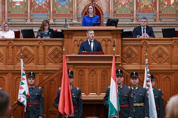 FILE - Hungary's Prime Minister Peter Magyar speaks, accompanied by Speaker of the Parliament Agnes Forsthoffer, top center, during the plenary session of the new National Assembly following the  ...