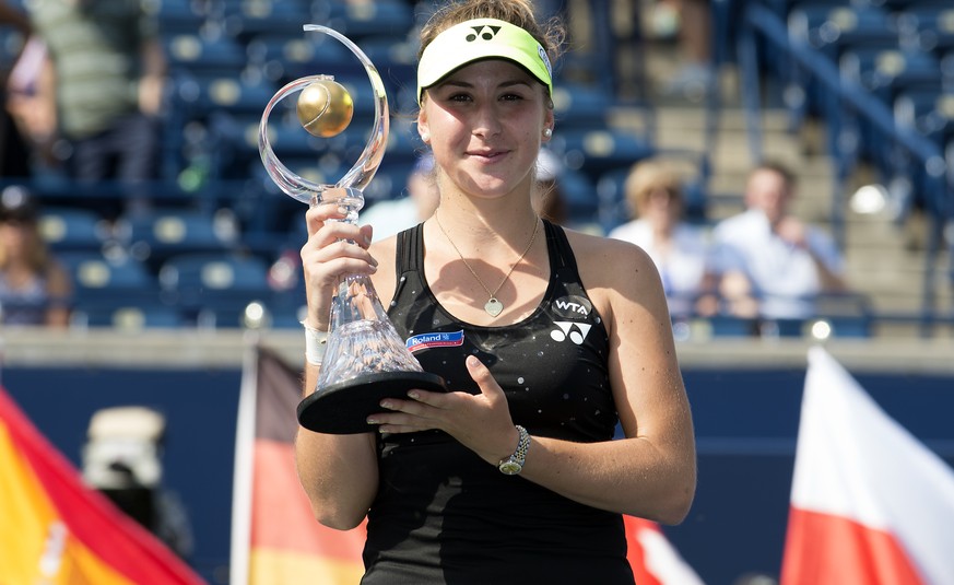 Aug 16, 2015; Toronto, Ontario, Canada; Belinda Bencic of Switzerland holds up the Rogers Cup trophy after winning the finals match against Simona Halep of Romania (not pictured) after Halep retired f ...