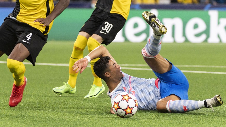 Manchester's Cristiano Ronaldo falls after a clash with YB players, during the UEFA Champions League group F soccer match between BSC Young Boys and Manchester United, on Tuesday, September 14, 2021 a ...