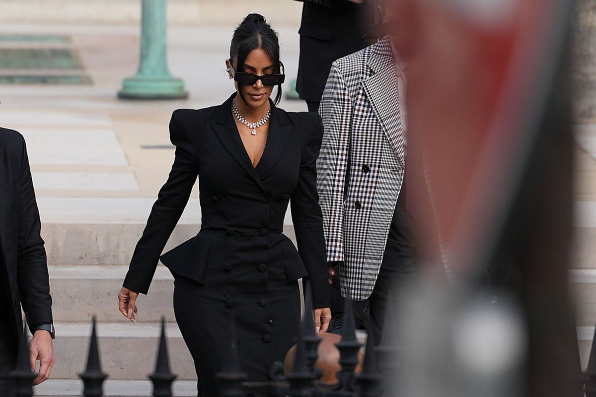 PARIS, FRANCE - MAY 13: Kim Kardashian exits the trial at the Palais de Justice, and wears sunglasses by Alaia, a black dress designed as a double breasted gathered blazer jacket with power shoulders  ...