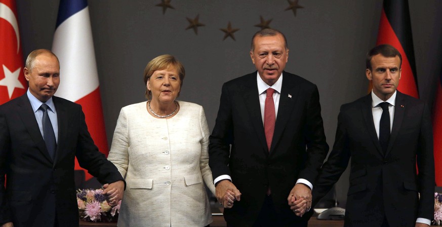 From left, Russian President Vladimir Putin, German Chancellor Angela Merkel, Turkey&#039;s President Recep Tayyip Erdogan and French President Emmanuel Macron pose at the end of a news conference fol ...