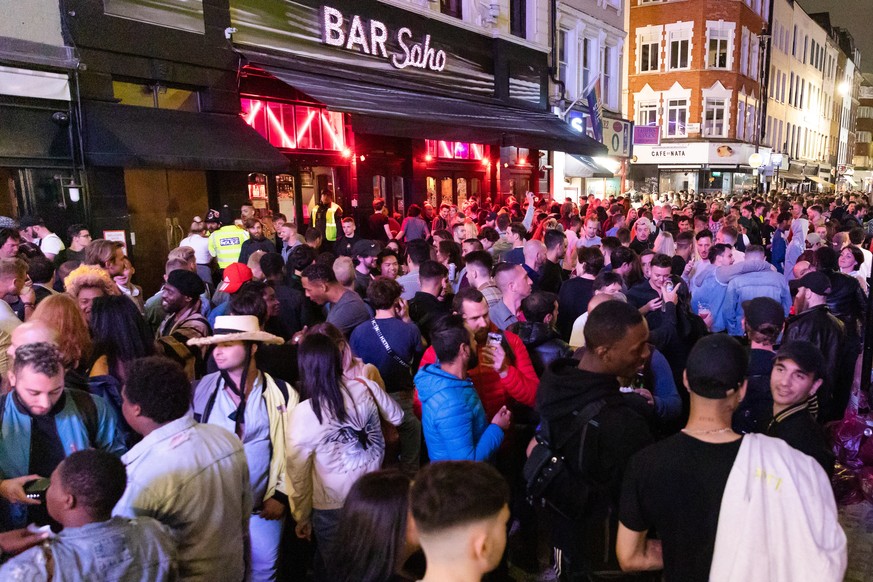 epa08528369 Revellers drink and socialize in the street during the evening in Soho, London, Britain, 04 July 2020 (issued 05 July 2020). Pubs, restaurants, places of worship, hairdressers and other bu ...