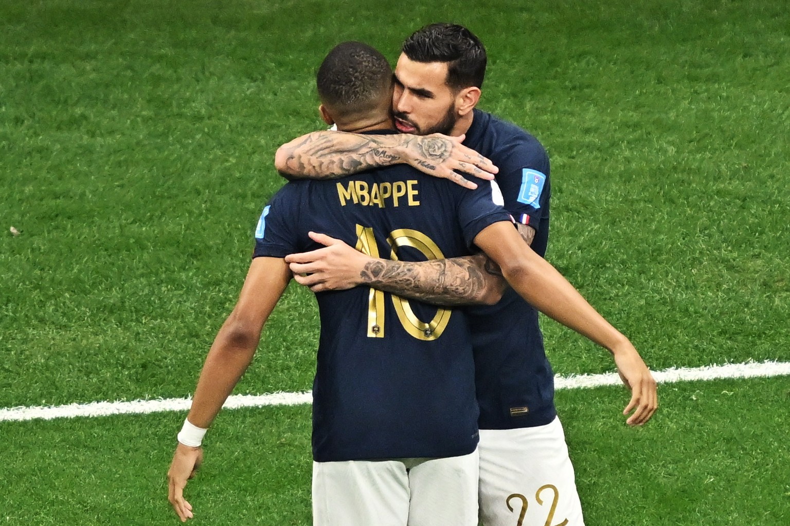 epa10365852 Theo Hernandez (R) of France celebrates scoring the 1-0 goal with his teammate Kylian Mbappe during the FIFA World Cup 2022 semi final between France and Morocco at Al Bayt Stadium in Al K ...