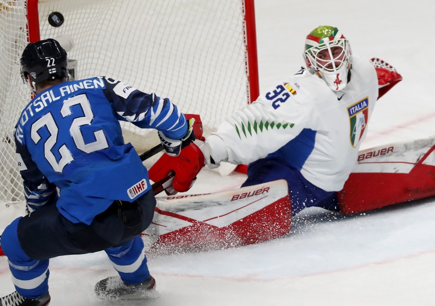 epa09231712 Arttu Ruotsalainen (L) of Finland in action against goalkeeper Justin Fazio of Italy during the IIHF 2021 World Ice Hockey Championships group B match between Finland and Italy at the Aren ...