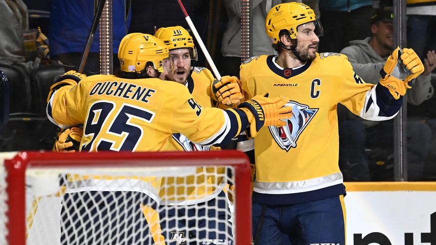 Nashville Predators center Colton Sissons (10) celebrates with Matt Duchene (95) and Roman Josi (59) after Sissons scored a goal against the Anaheim Ducks during the second period of an NHL hockey gam ...