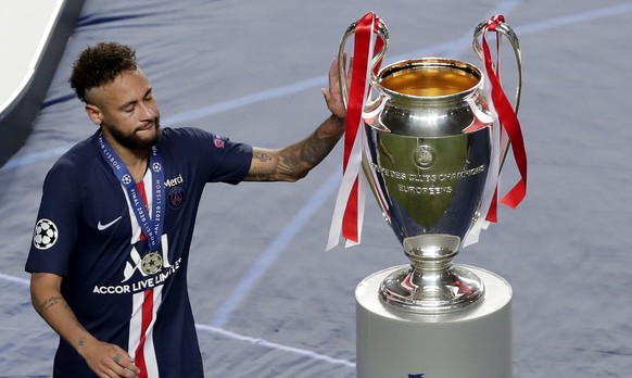 epa08620908 Neymar of PSG touches the trophy after receiving his runner-up medal after the UEFA Champions League final between Paris Saint-Germain and Bayern Munich in Lisbon, Portugal, 23 August 2020 ...