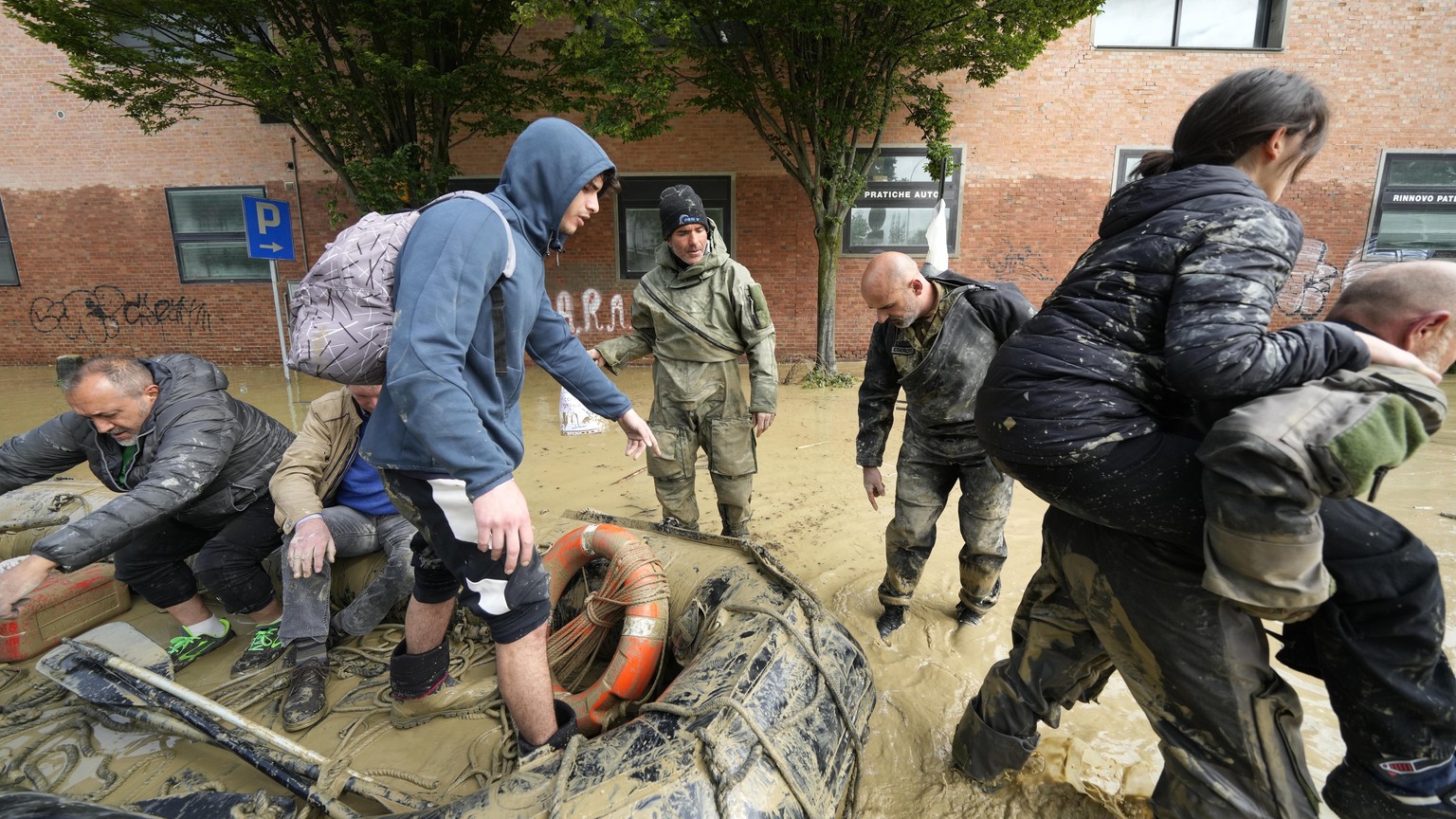 FILE - People are rescued in Faenza, Italy, May 18, 2023. The floods that sent rivers of mud tearing through towns in Italy?s northeast are another soggy dose of climate change&#039;s all-or-nothing w ...