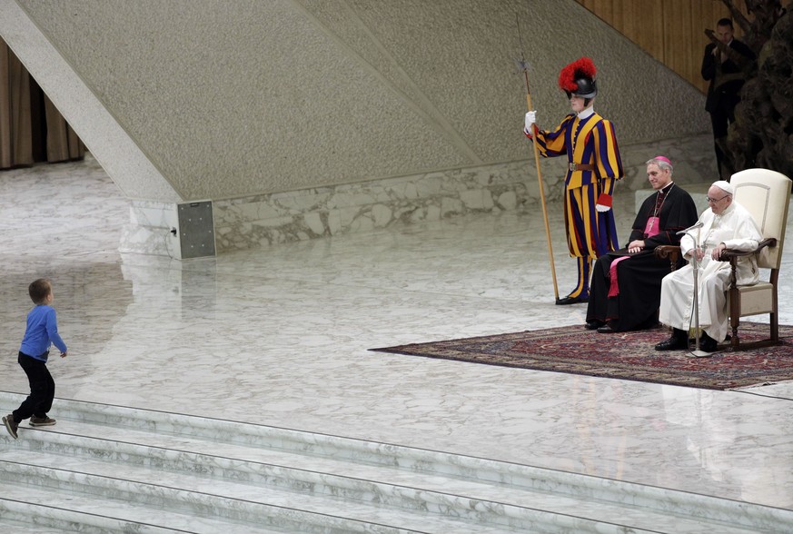 A child makes his way to the stage during Pope Francis weekly general audience, in the Paul VI Hall at the Vatican, Wednesday, Nov. 28, 2018. Pope Francis has praised the freedom, albeit undisciplined ...