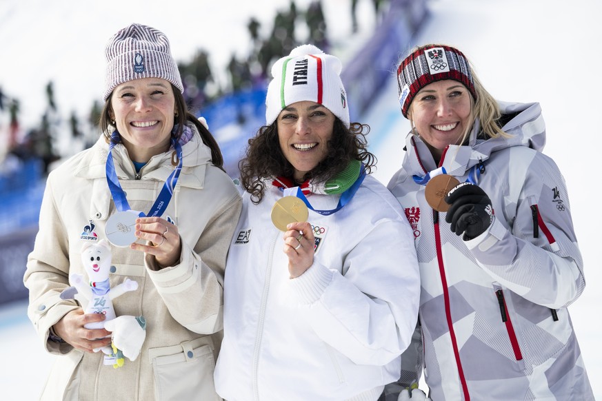 epa12730795 Silver medalist Romane Miradoli of France, gold medalist Federica Brignone of Italy and bronze medalist Cornelia Huetter of Austria, from left, pose on the podium after the women's al ...