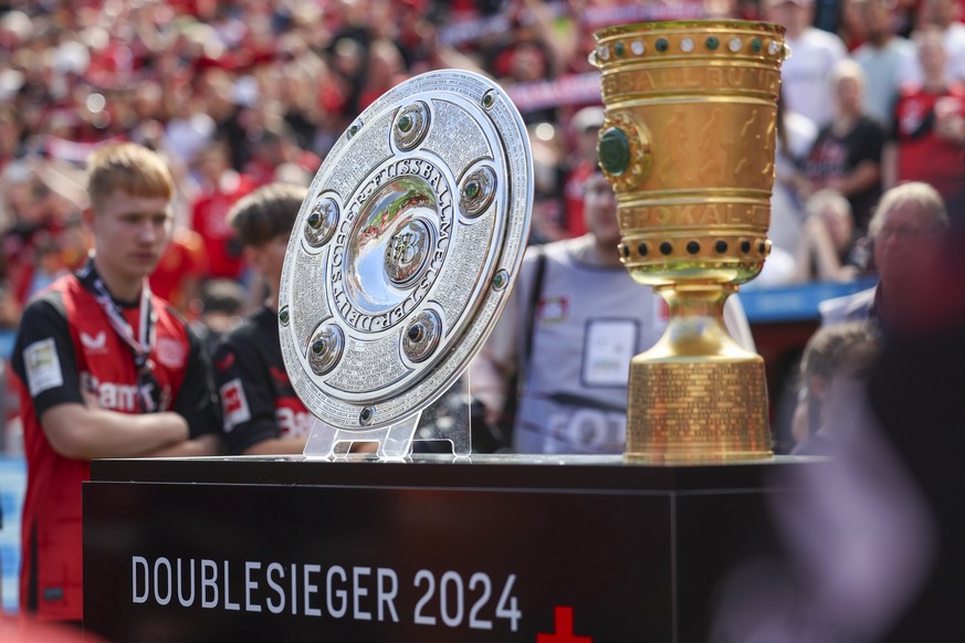 epa11542676 The German Championship and Cup trophies won by Bayer Leverkusen on display prior to the friendly soccer match between Bayer 04 Leverkusen and Real Betis in Leverkusen, Germany, 10 August  ...