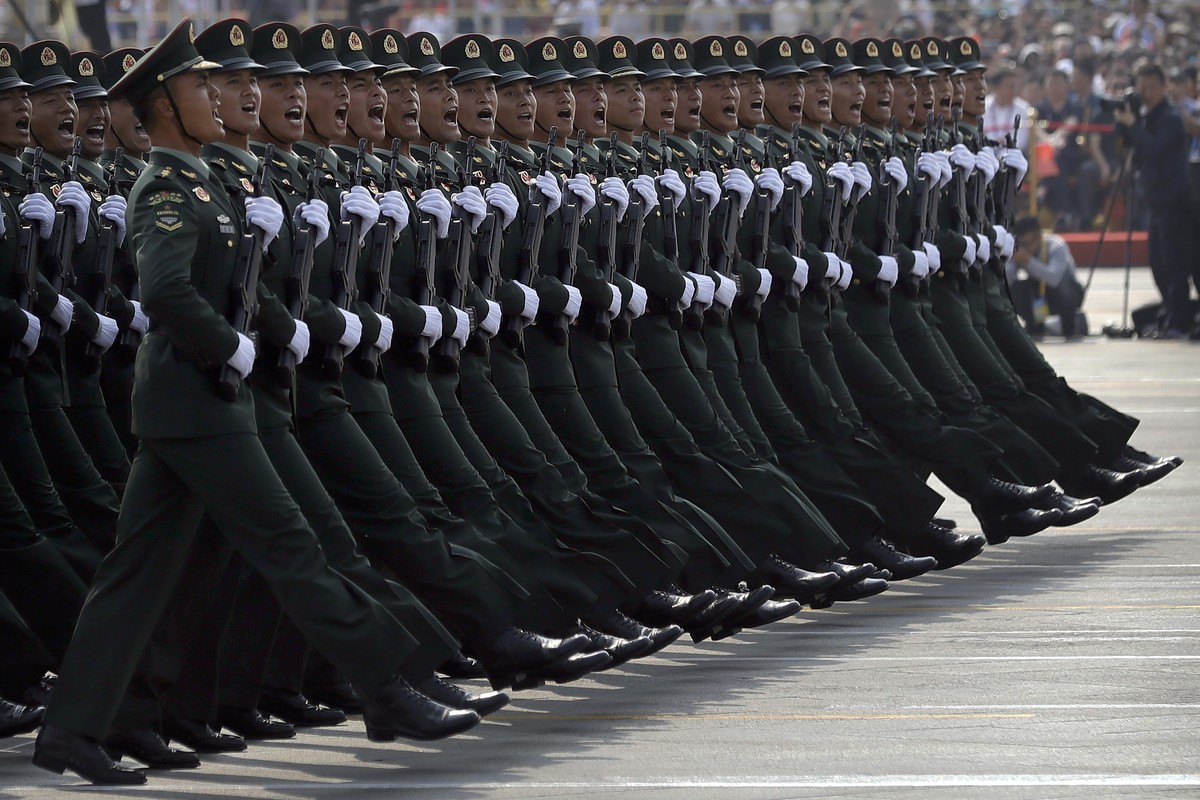 Soldiers from China's People's Liberation Army (PLA) march in formation during a parade to commemorate the 70th anniversary of the founding of Communist China in Beijing, Tuesday, Oct. 1, 20 ...