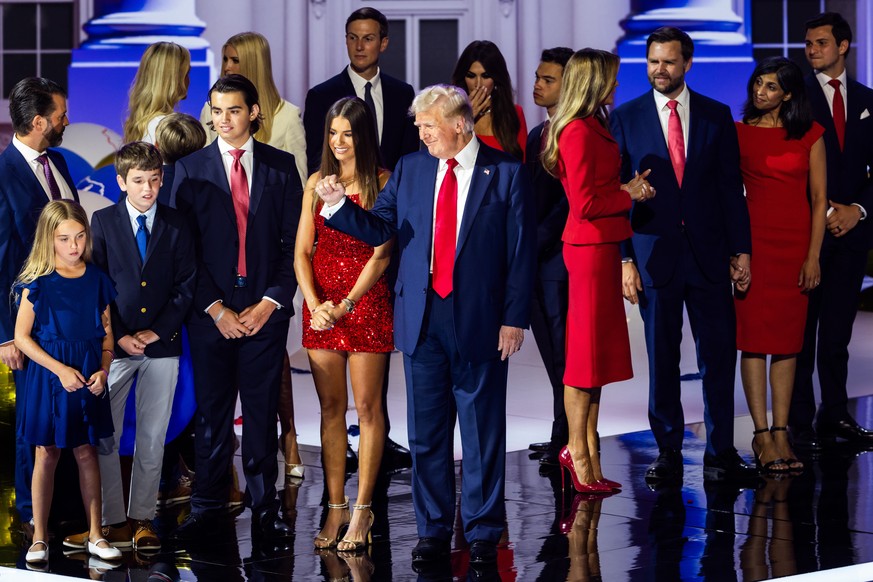 epa11486763 Republican presidential nominee and former President Donald Trump (C), surrounded by members of his family, celebrates after speaking during the last day of the Republican National Convent ...
