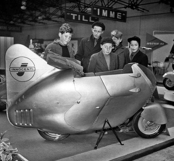 Children look at a Lambretta scooter during the 21st Geneva International Motor Show in Switzerland, pictured in March 1951. (KEYSTONE/PHOTOPRESS-ARCHIV/Str) === , === : FILM, medium format]Youth...