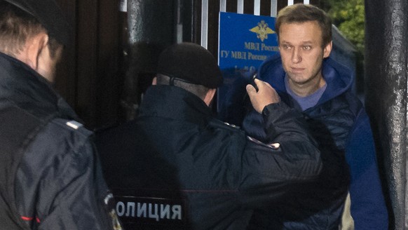 Police officers detain Russian opposition activist Alexei Navalny as he leaves a detention center after a month in jail for an unsanctioned protest rally, in Moscow, Russia, Monday, Sept. 24, 2018. (A ...