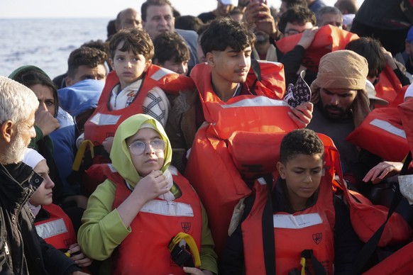 Migrants wear life vests as they are rescued by a MSF (Medecins Sans Frontiers) rescue team boat, after leaving Libya trying to reach European soil, in the Mediterranean Sea, Friday, Oct. 6, 2023. (AP ...