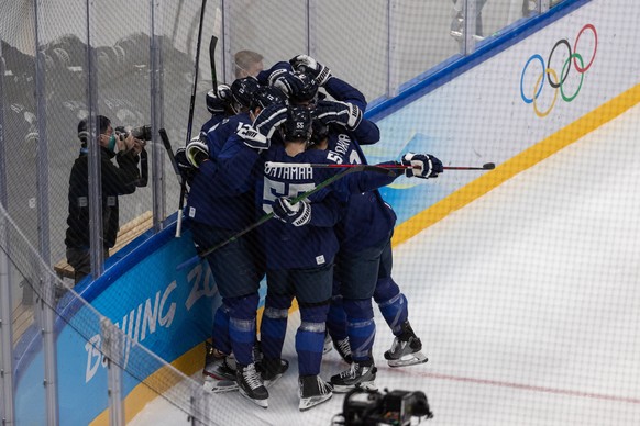 epa09761756 Finnish players react after scoring during the Men&#039;s Ice Hockey Play-off Quarterfinal match between Finland and Switzerland at the Beijing 2022 Olympic Games, Beijing, China, 16 Febru ...