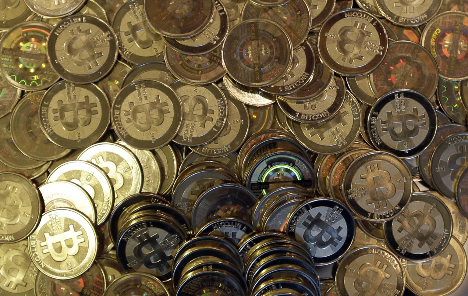 FILE - This April 3, 2013, file photo shows bitcoin tokens in Sandy, Utah. Unidentified hackers broke into the Twitter accounts of technology moguls, politicians, celebrities and major companies Wedne ...