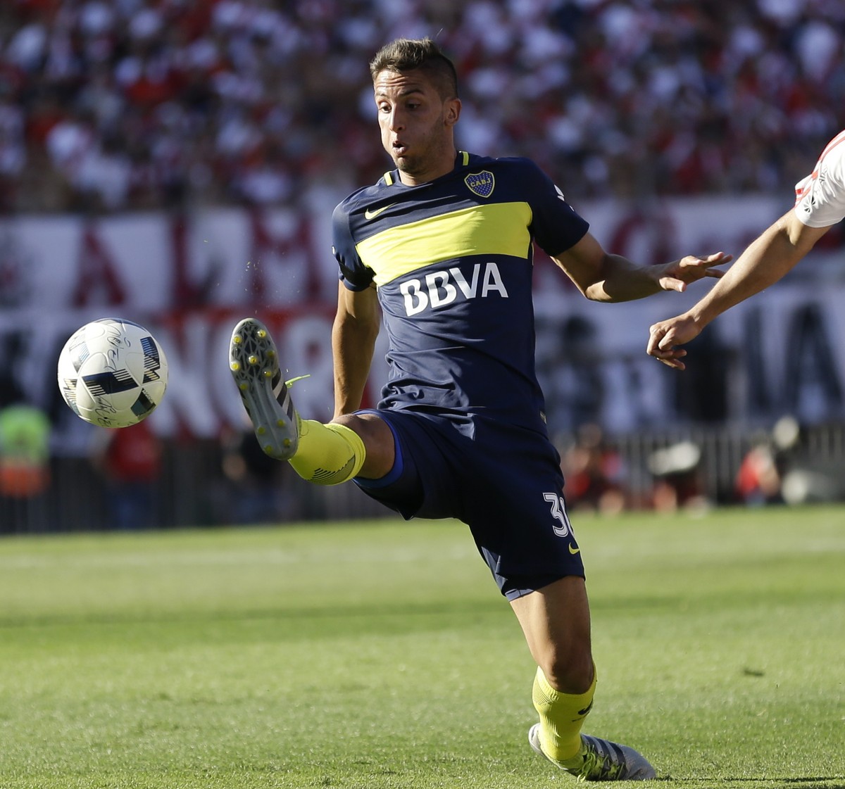 Boca Juniors' midfielder Rodrigo Bentancur, left, kicks the ball next to River Plate's defender Jorge Moreira during their Argentine soccer derby in Buenos Aires, Argentina, Sunday, Dec. 11, ...