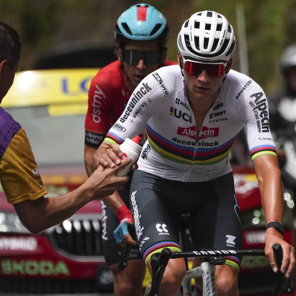 Netherlands&#039; Mathieu van der Poel takes a drinking bottle during the fourteenth stage of the Tour de France cycling race over 151.9 kilometers (94.4 miles) with start in Pau and finish in Saint-L ...