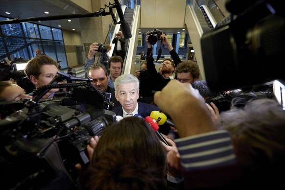 epa04069570 Dutch Minister of the Interior and Kingdom Relations, Ronald Plasterk (C) talks to the press as he arrives at the parliament in The Hague, The Netherlands, 11 February 2014. Plasterk and h ...