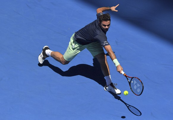 Switzerland&#039;s Stan Wawrinka runs to make a forehand return to Lithuania&#039;s Ricardas Berankis during their first round match at the Australian Open tennis championships in Melbourne, Australia ...
