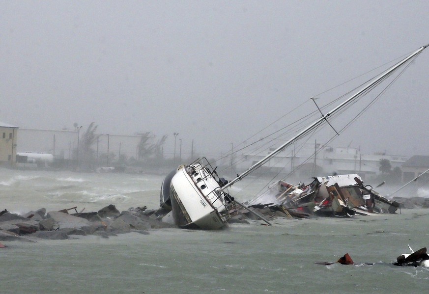 In this Sunday, Sept. 10, 2017, photo, a sailboat crashes on the shore near Mallory Square as Hurricane Irma moves into the Florida Straits on Key West, Fla. (Charles Trainor Jr/Miami Herald via AP)