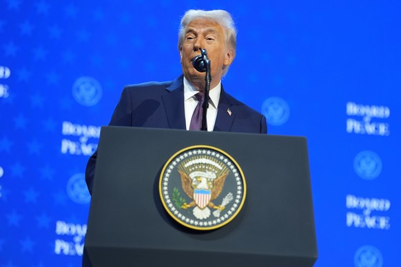 President Donald Trump speaks during a Board of Peace charter announcement during the Annual Meeting of the World Economic Forum in Davos, Switzerland, Thursday, Jan. 22, 2026. (AP Photo/Evan Vucci)
D ...