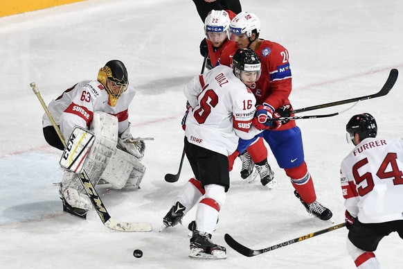 Switzerland’s Switzerland’s goaltender Leonardo Genoni, left, and Switzerland’s Rafael Diaz, center, in action against Norway’s Martin Roymark, center left, and Norway’s Andreas Martinsen during their ...