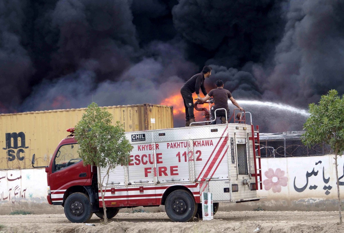 epa13035030 Firefighters battle a blaze at a customs office on Tank Road near Korai in Dera Ismail Khan, Pakistan, 13 June 2026. Authorities said part of the blaze had been brought under control while ...