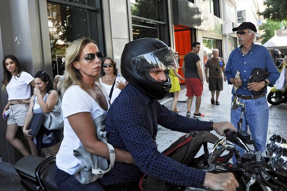 epaselect epa04833707 Greece's former Finance Minister Yanis Varoufakis drives his motorcyle with his wife Danae Stratou after exiting the Finance Ministry in Athens, Greece, 05 July 2015. Greece's Fi ...