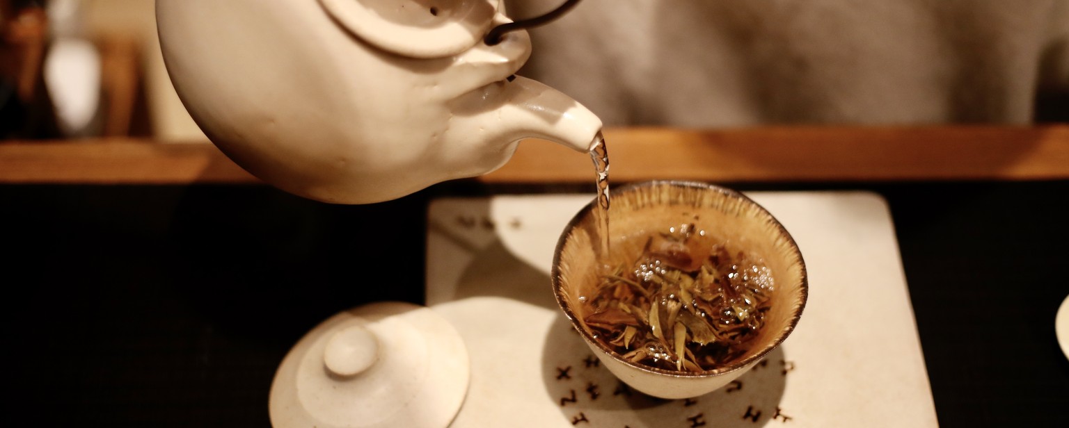 epa08956951 Tea Master Chia Yu Chuang pours hot water to a white tea to taste at a tea store and storage, in Yilan, Taiwan, 20 January 2021(issued 22 January 2021). Chuang, operating and owned a tea s ...