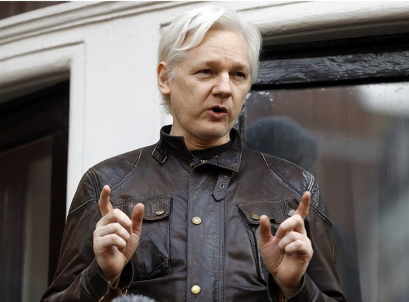 FILE - In this May 19, 2017 file photo, WikiLeaks founder Julian Assange gestures to supporters outside the Ecuadorian embassy in London, where he has been in self imposed exile since 2012. Former Tru ...