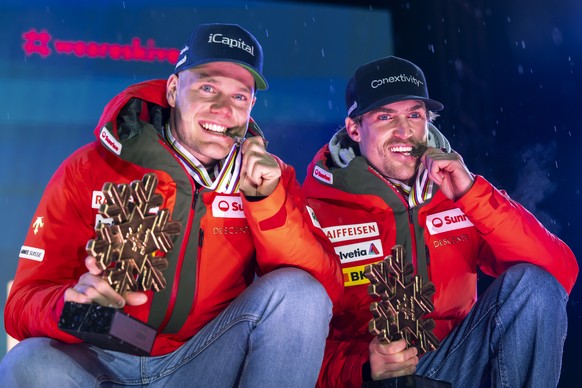 Bronze medalists Stefan Rogentin of Switzerland, left, and Marc Rochat of Switzerland, right, pose with medal during the medals ceremony of the men's Team Combined at the 2025 FIS Alpine World Sk ...