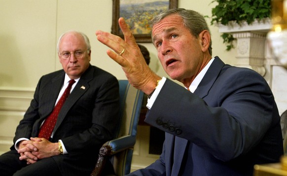 FILE - President George W. Bush, right, with Vice President Dick Cheney at his side, speaks during a meeting with congressional leaders in the White House Oval Office on Sept. 18, 2002. A new CNN Film ...