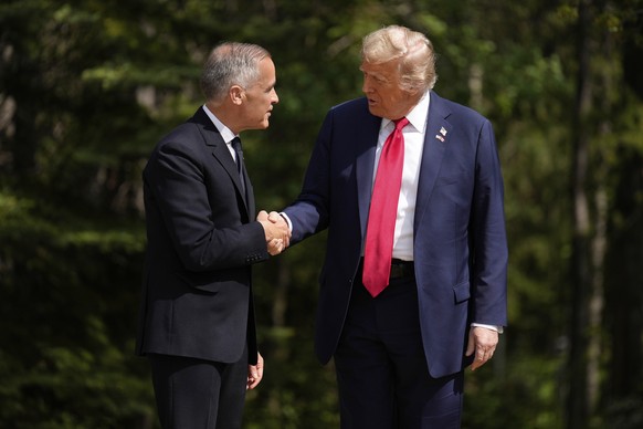 Canada&#039;s Prime Minister Mark Carney greets President Donald Trump during the official welcome of the G7 Summit, Monday, June 16, 2025, in Kananaskis, Canada. (AP Photo/Mark Schiefelbein)
Donald T ...