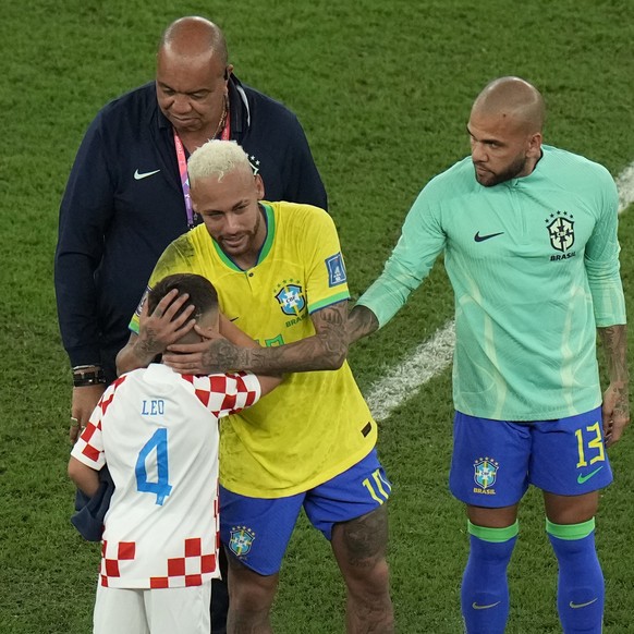 Brazil's Neymar hugs a child wearing Croatian jersey after Brazil lost the World Cup quarterfinal soccer match against Croatia, at the Education City Stadium in Al Rayyan, Qatar, Friday, Dec. 9, ...