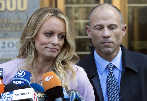 In this April 16, 2018 file photo, adult film actress Stormy Daniels, whose given name is Stephanie Clifford, and her attorney Michael Avenatti talk to reporters outside federal court in New York City ...