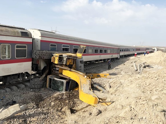 epa10001462 A handout photo made available by the Iranian Red Crescent Society (IRCS) shows the aftermath of the collision between a train and an excavator near Tabas, Yazd province, Iran, 08 June 202 ...