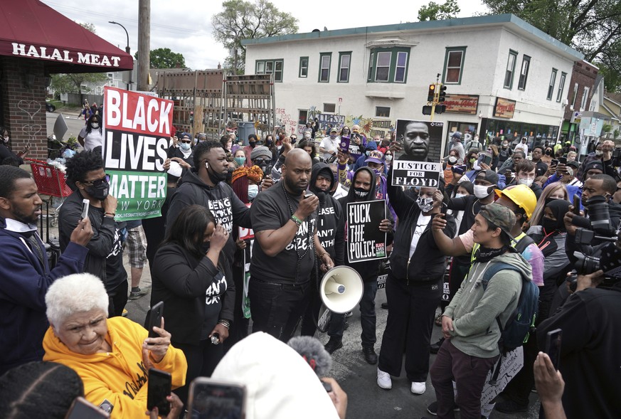 Peaceful protesters, including actor and comedian Nick Cannon (next to man with megaphone) celebrate the memory of George Floyd and demand justice outside the Cup Foods store on Chicago Avenue where F ...