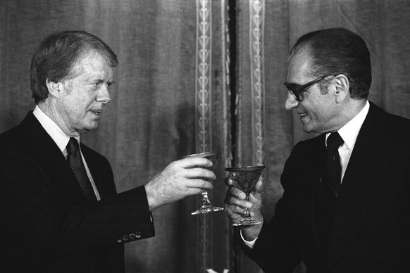 FILE - In this Dec. 31, 1977 file photo, U.S. President Jimmy Carter toasts Shah Mohammad Reza Pahlavi of Iran during a New Year&#039;s Eve dinner at Niavaran Palace in Tehran, Iran. This moment came  ...