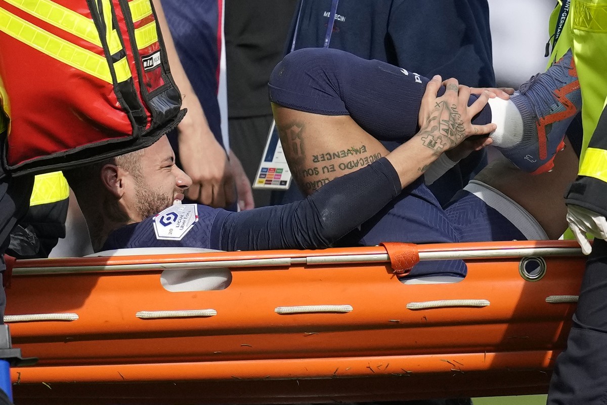 PSG's Neymar is carried off the field on a stretcher after after injuring during the French League One soccer match between Paris Saint-Germain and Lille at the Parc des Princes stadium, in Paris ...