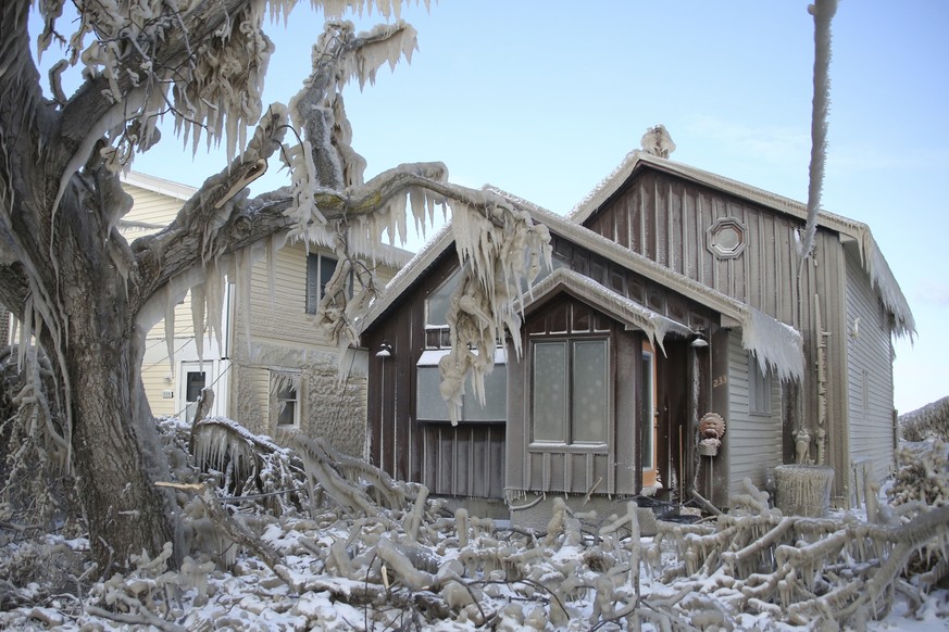 A house along Hoover Beach is covered by ice from high winds and from the waves from Lake Erie, Saturday, Feb. 29, 2020, in Hamburg N.Y. Blowing snow has fallen around the state since Thursday, though ...